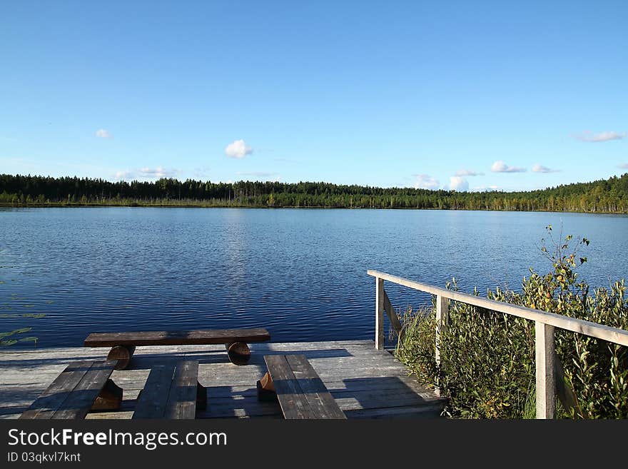 Forest lake. Summer landscape. Pier.