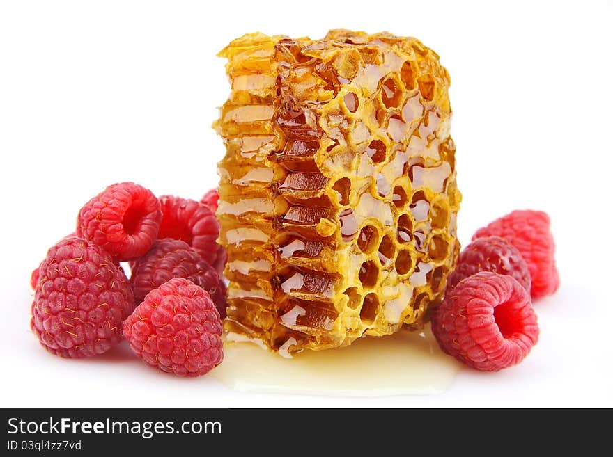 Raspberries and honeycomb close up