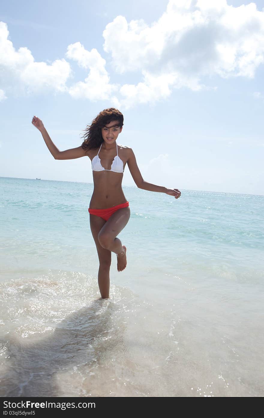 Asian Brunette Beautiful woman wearing bikini on the beach in Miami Beach. Asian Brunette Beautiful woman wearing bikini on the beach in Miami Beach