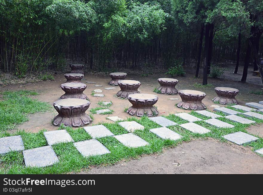 Bench on alley in a park near forest