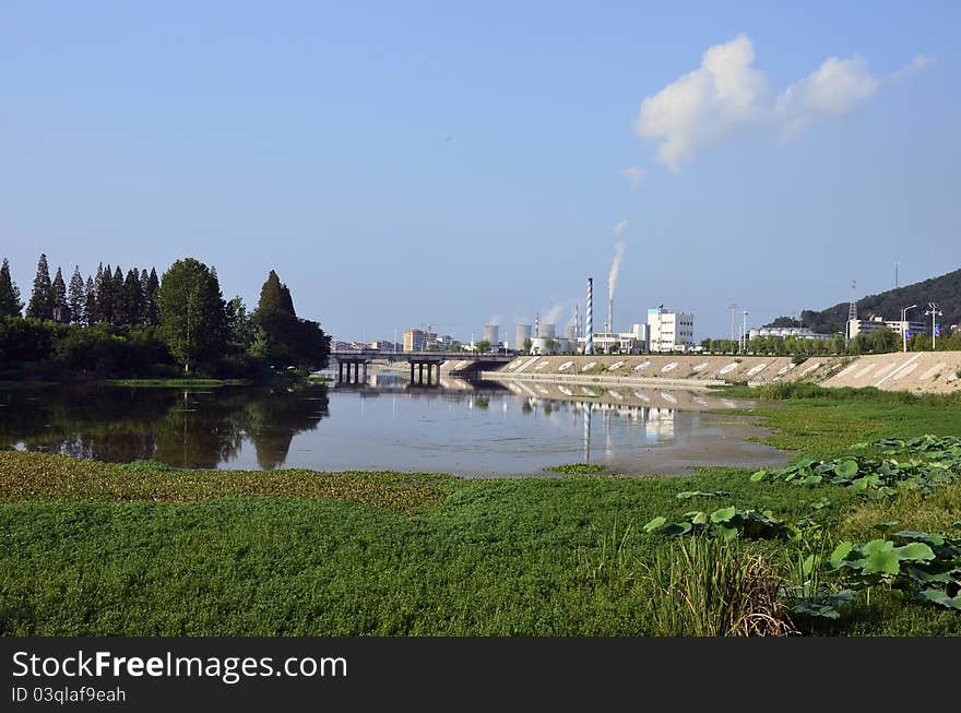 City pollution near green park with lake