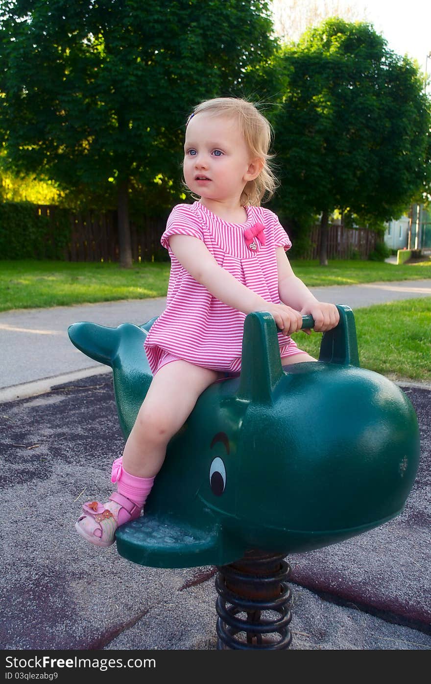 A baby girl on the playground