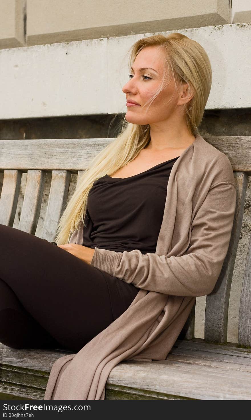 Woman sitting on a bench.