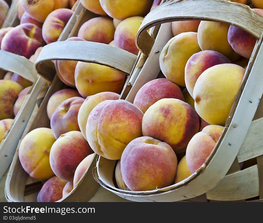 Fresh peaches in baskets at a market. Fresh peaches in baskets at a market