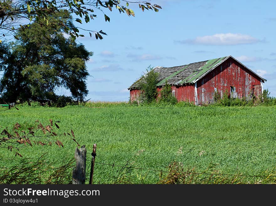 Picture of barn in field against blue sky. Picture of barn in field against blue sky.