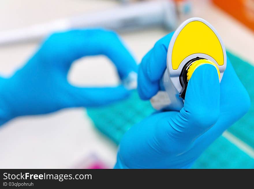 Pipette with drop of liquid in test tube