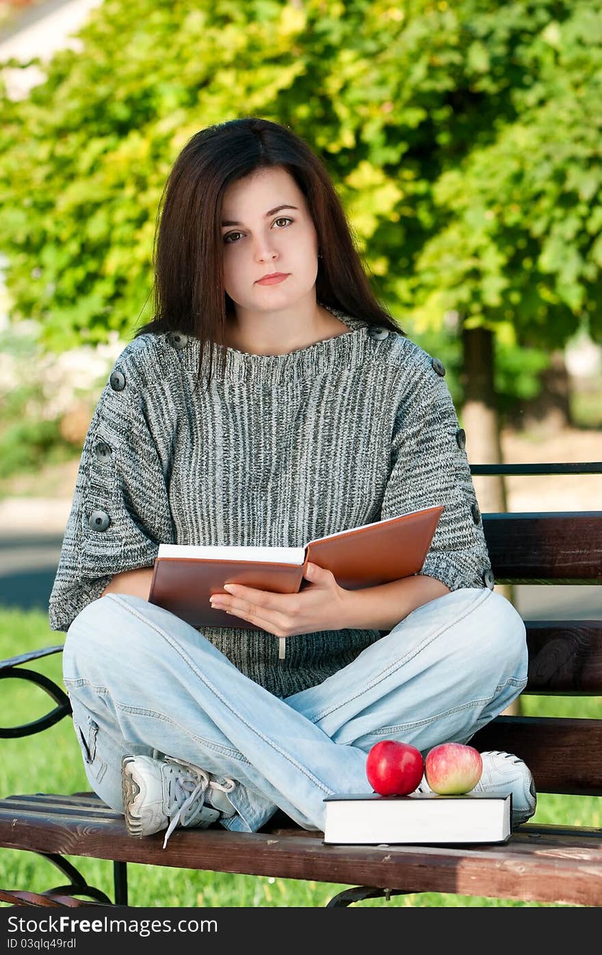 Portrait of a young female student with books at the campus