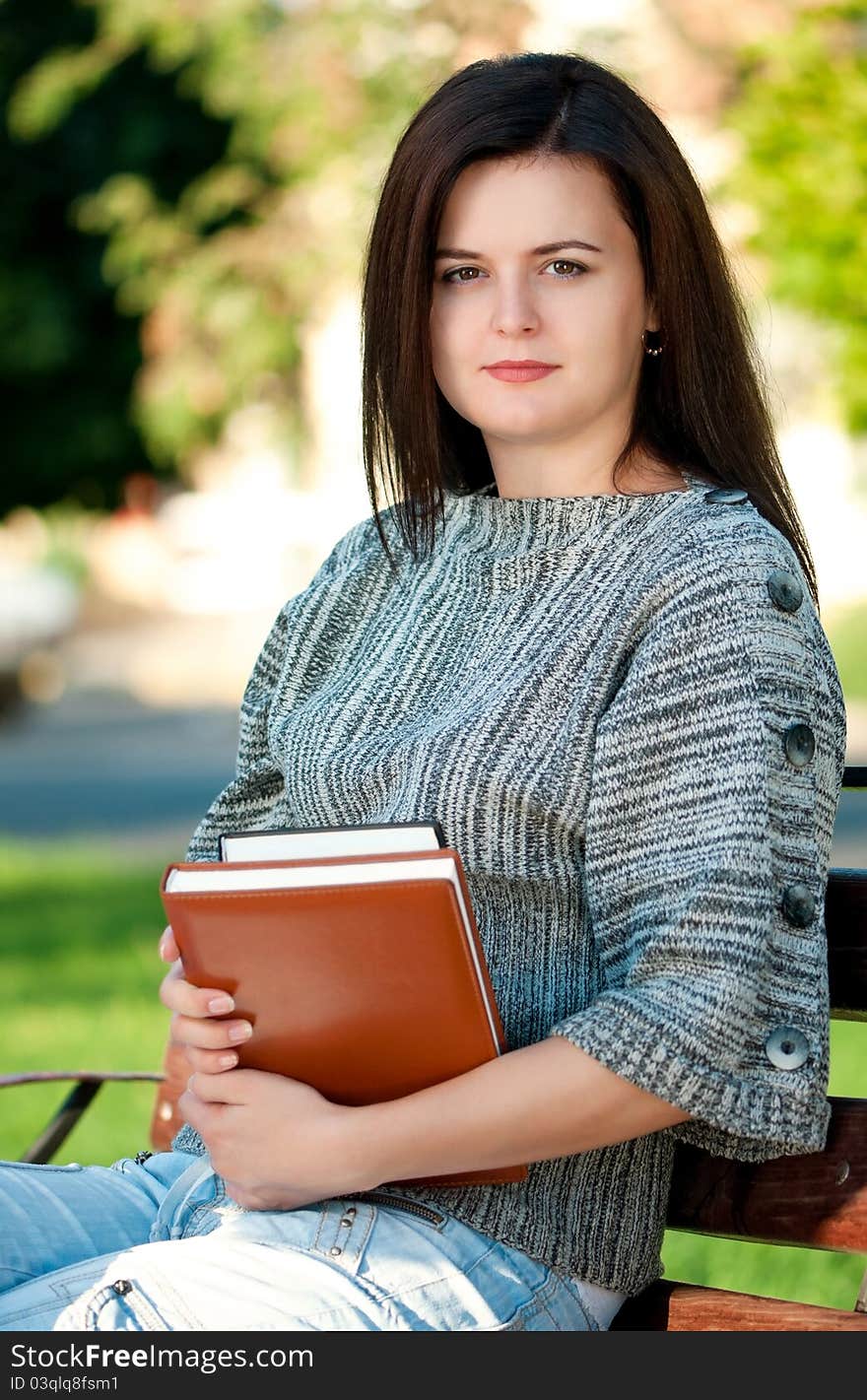 Portrait of a young female student with books at the campus