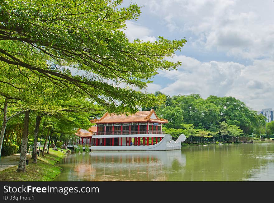 Old chinese building with water clouds and trees