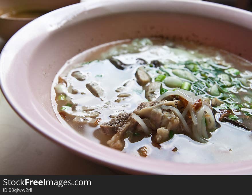 Vietnamese style noodle with pork in pink bowl. Vietnamese style noodle with pork in pink bowl.