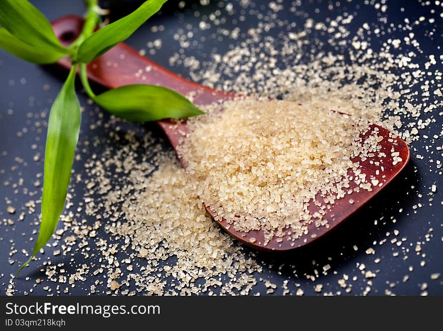 Wooden spoon with brown granulated sugar. Wooden spoon with brown granulated sugar