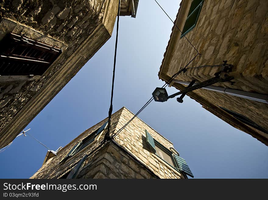 View up high on old stone houses and blue sky in Tribunj