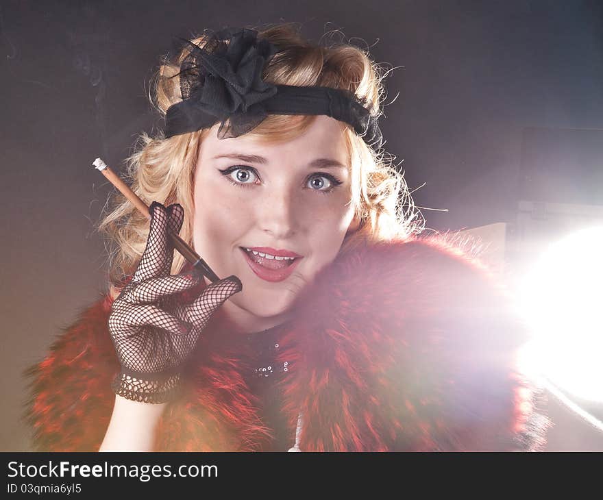 Retro girl smoking a cigar in his hand