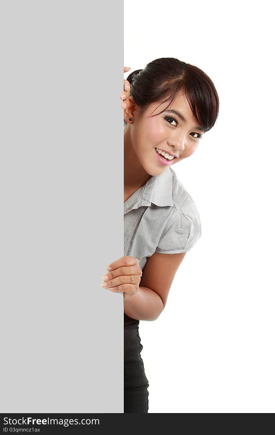 Happy young business woman showing blank signboard, isolated on white background