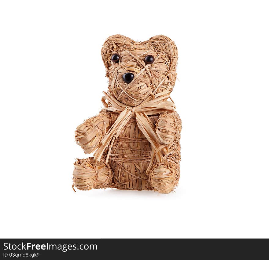 Small Toy bear from straw on white.