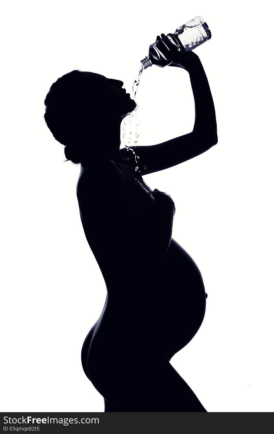 Beautiful silhouette of pregnant woman drinking water