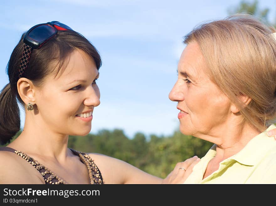 Cute mom and her adult daughter at nature. Cute mom and her adult daughter at nature