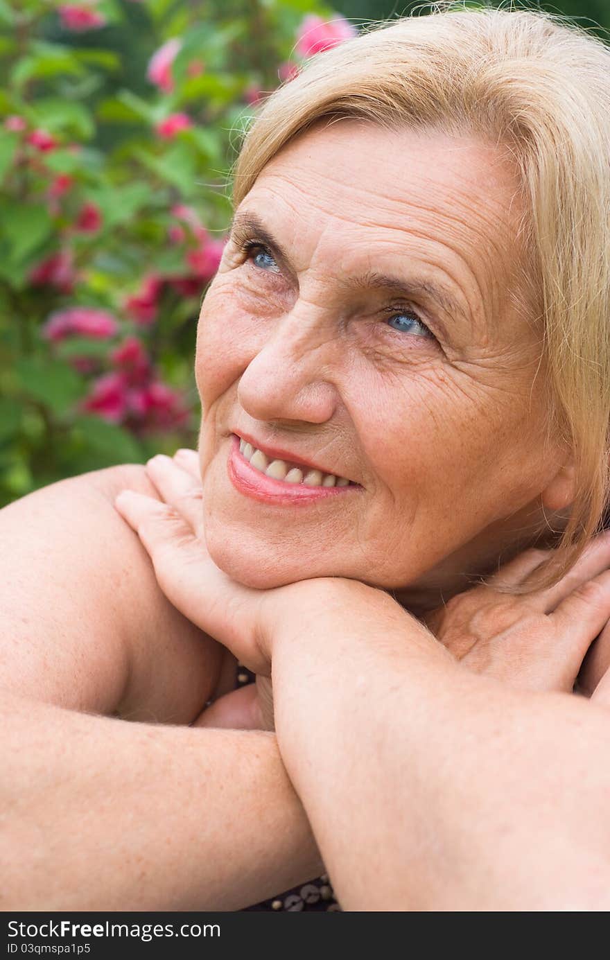 Portrait of a cute aged woman at nature. Portrait of a cute aged woman at nature