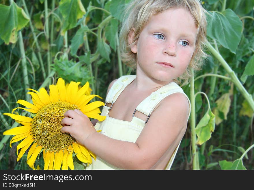 Toddler girl with sunflower outdoor