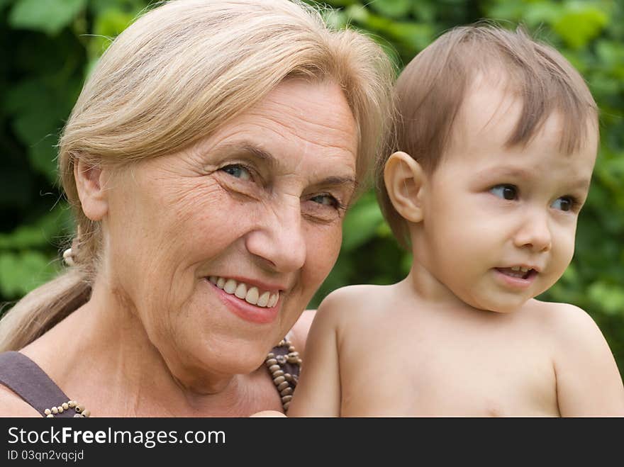 Happy granny with a baby at nature. Happy granny with a baby at nature