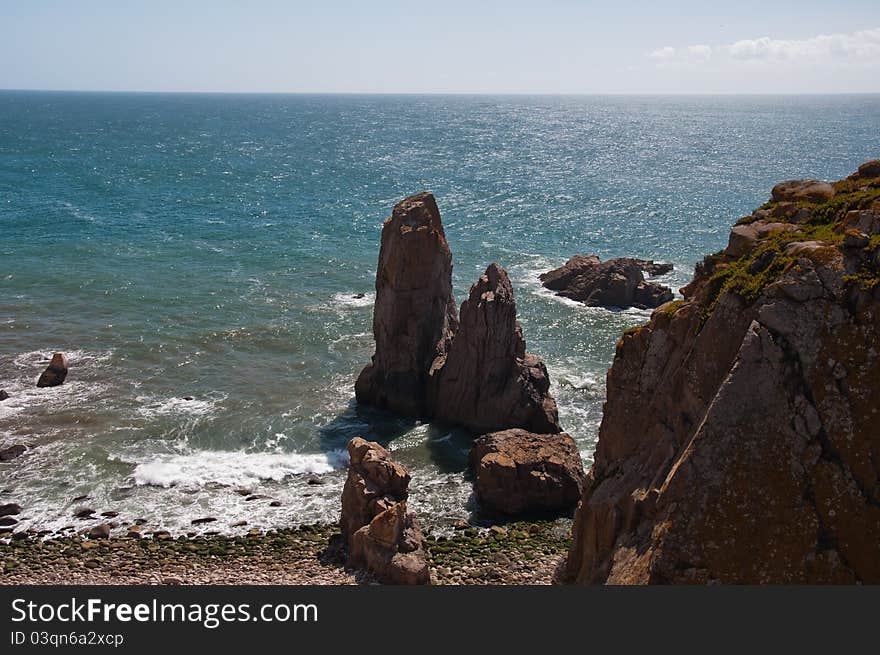 Cabo da Roca (Cape Roca) is a cape which forms the westernmost point of both mainland Portugal and mainland Europe. The cape is in the Portuguese municipality of Sintra, west of Lisbon district, and also forms the westernmost extent of the Serra de Sintra. Cabo da Roca (Cape Roca) is a cape which forms the westernmost point of both mainland Portugal and mainland Europe. The cape is in the Portuguese municipality of Sintra, west of Lisbon district, and also forms the westernmost extent of the Serra de Sintra