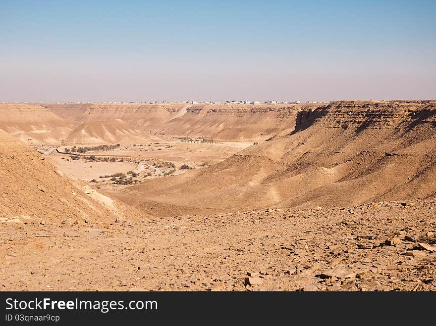 A village which overhangs a cliff in the desert. A village which overhangs a cliff in the desert