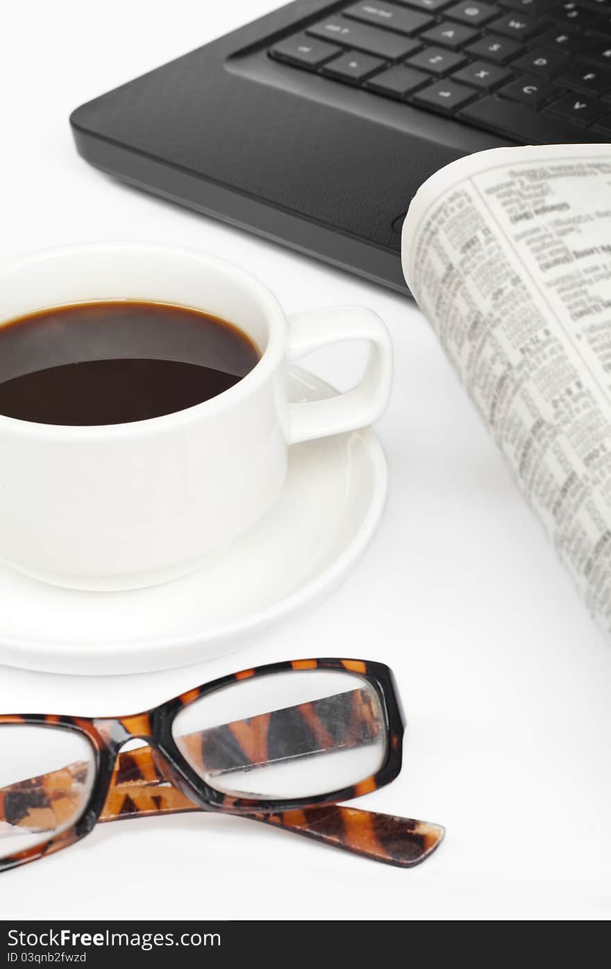 A cup of coffee,newspaper and notebook on white background