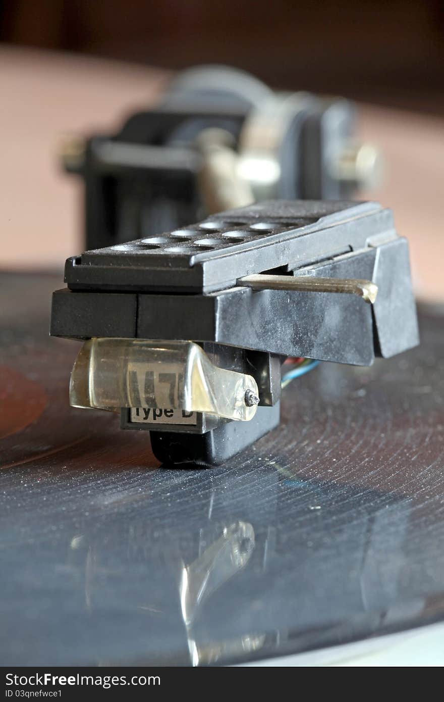 Close-up view of a record player spinning an lp vinyl record with its reflection (selective focus)