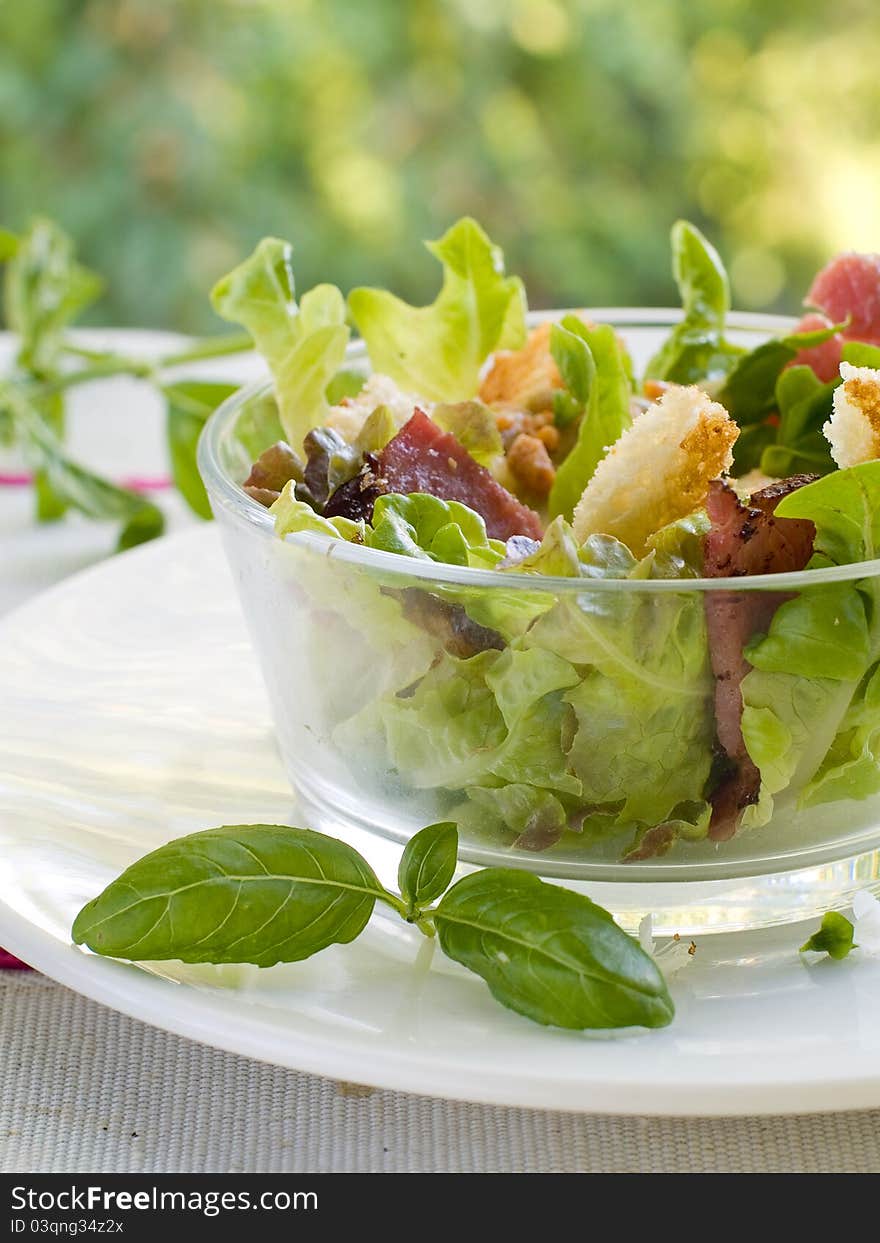 Fresh salad from lettuce, croutons and bacon. Selective focus. Fresh salad from lettuce, croutons and bacon. Selective focus