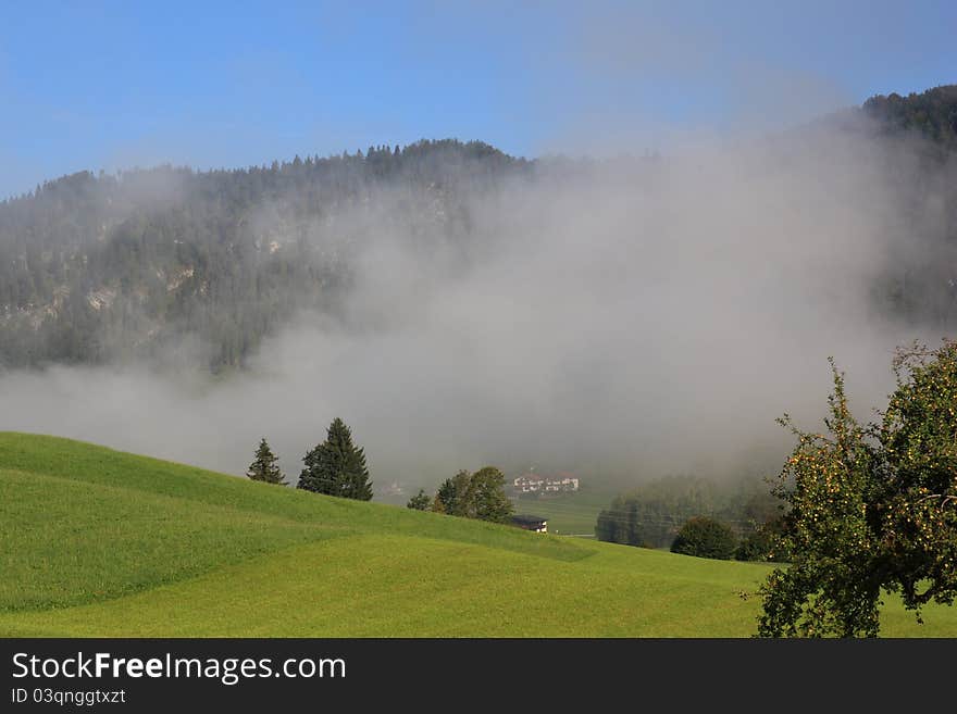 Fog over the landscape with mouintans behind, Walchsee in Austria. Fog over the landscape with mouintans behind, Walchsee in Austria