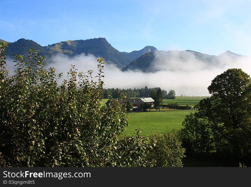 Fog over the landscape with mouintans behind, Walchsee in Austria. Fog over the landscape with mouintans behind, Walchsee in Austria