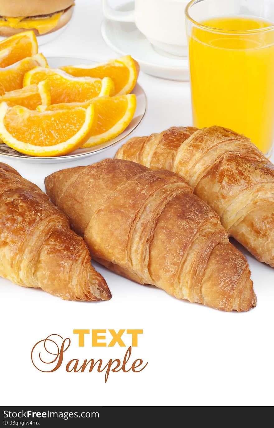 Croissant bun with orange juice on white background with text sample