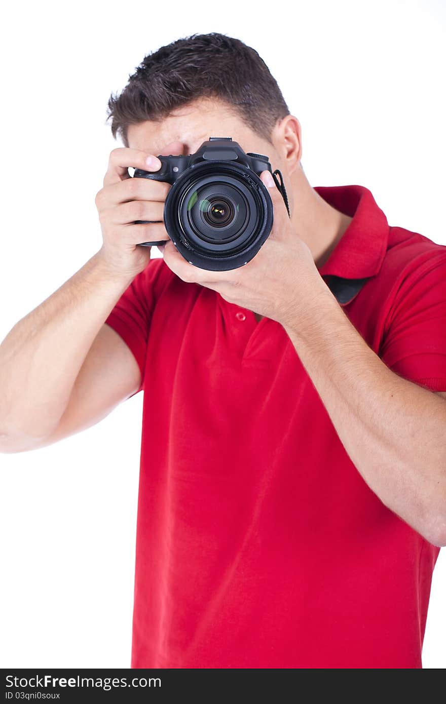 Young photographer standing and shooting with his camera. Young photographer standing and shooting with his camera