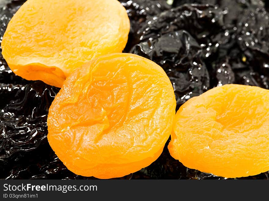 Some pieces of dried apricots lying on prunes (small depth of sharpness). Some pieces of dried apricots lying on prunes (small depth of sharpness)