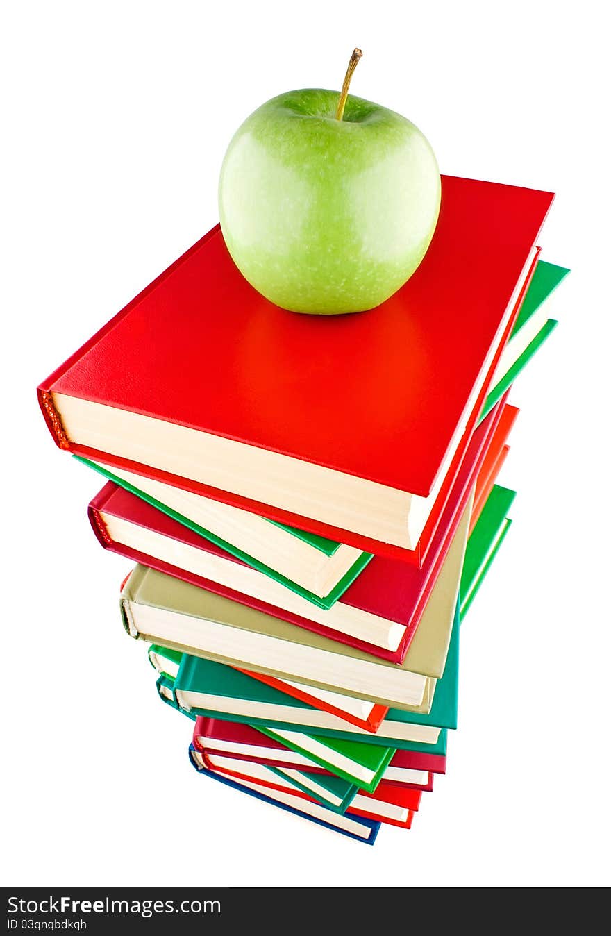 Stack of books with green apple on top on white background