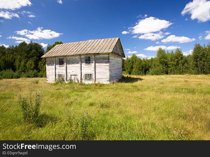 The old wooden thrown house which is in countryside (in the field about wood)