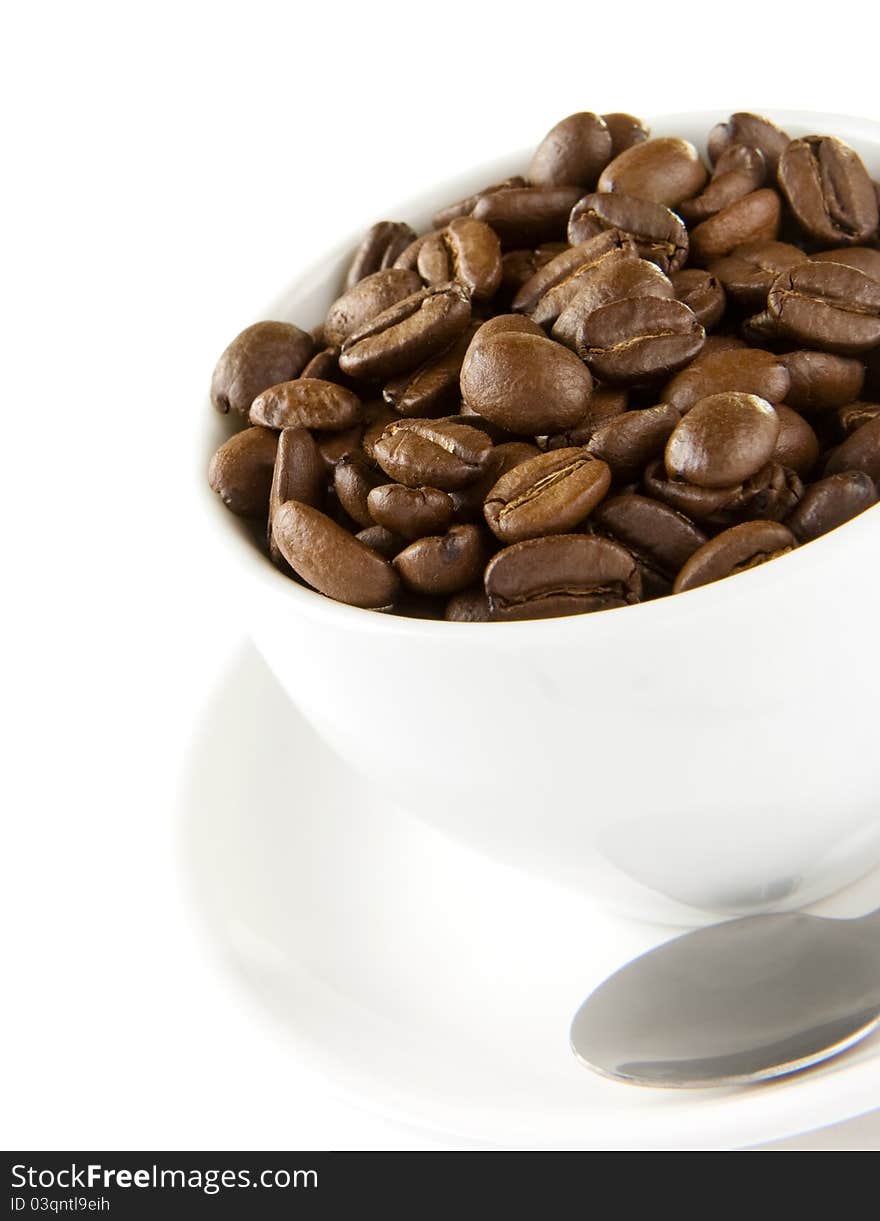 Cup of coffee and beans on white