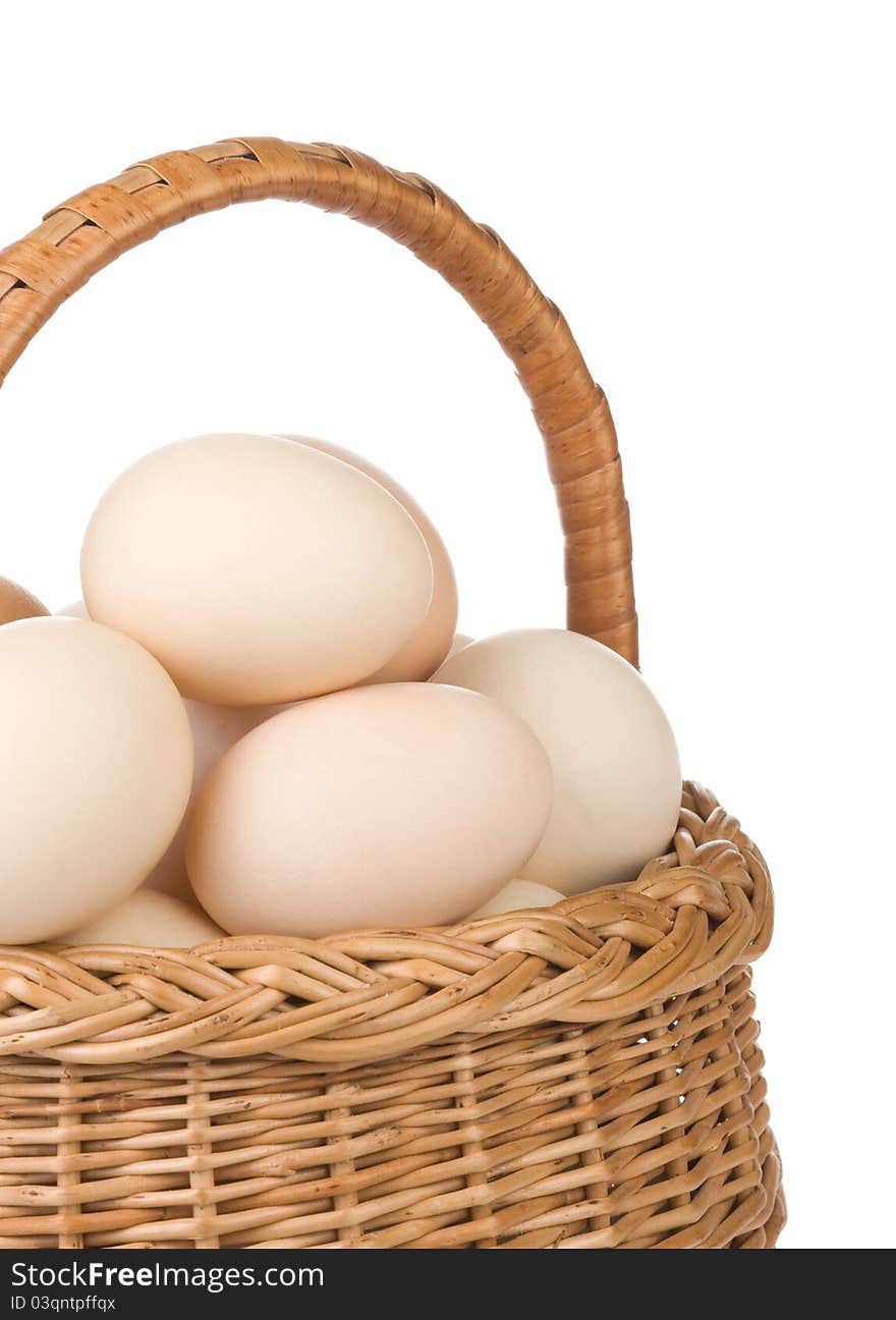 Eggs and basket on white background