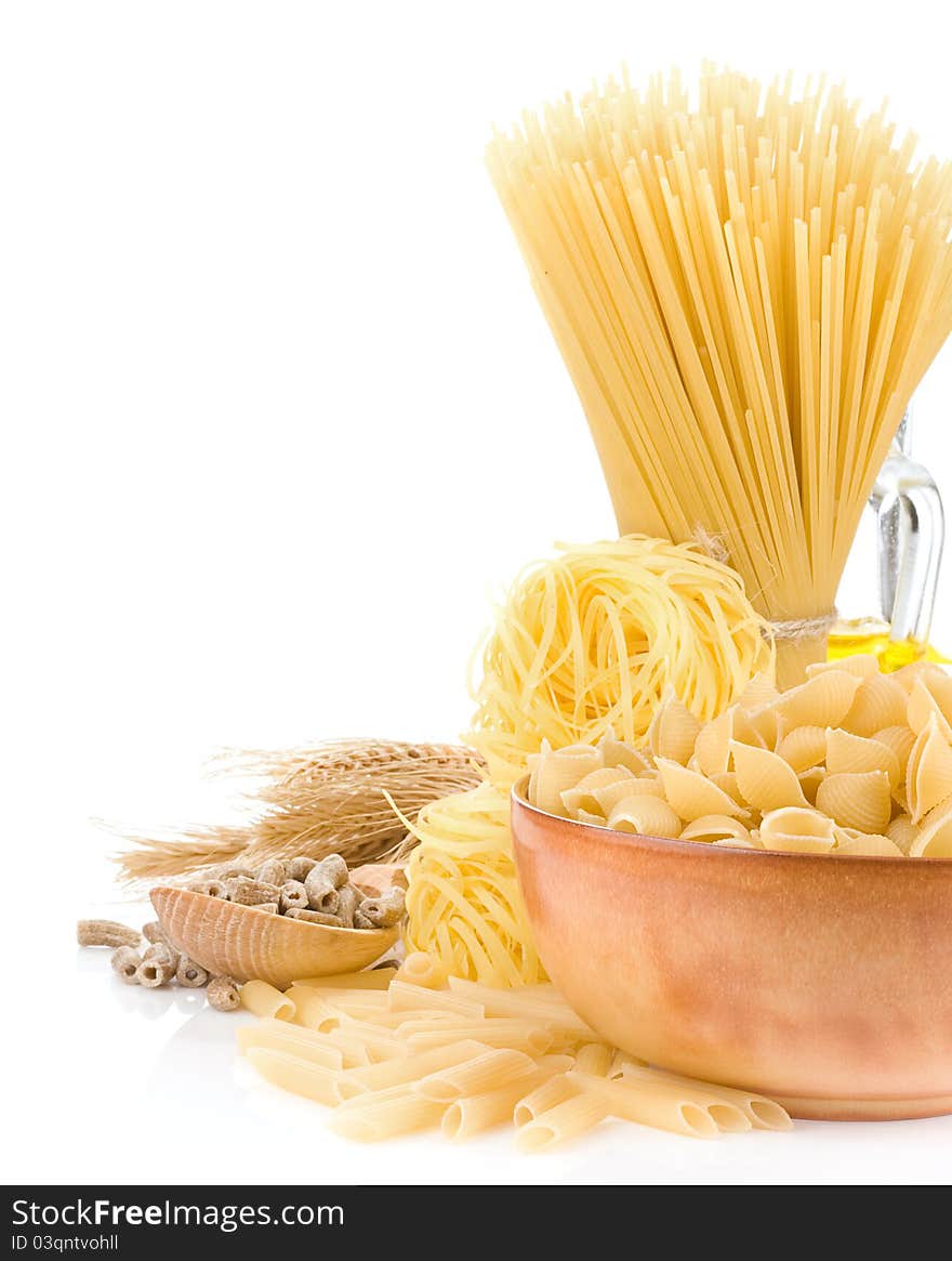 Pasta and wooden plate on white background