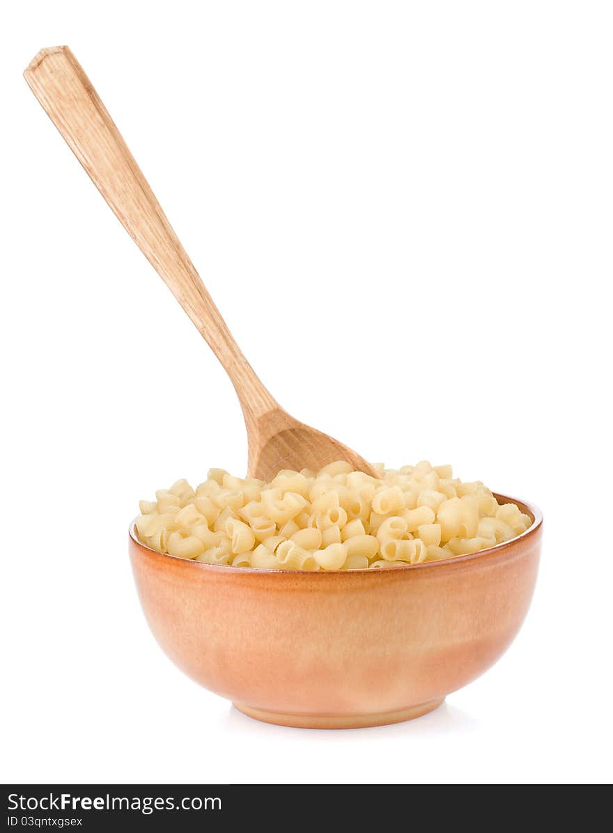 Raw pasta and wooden spoon on white background