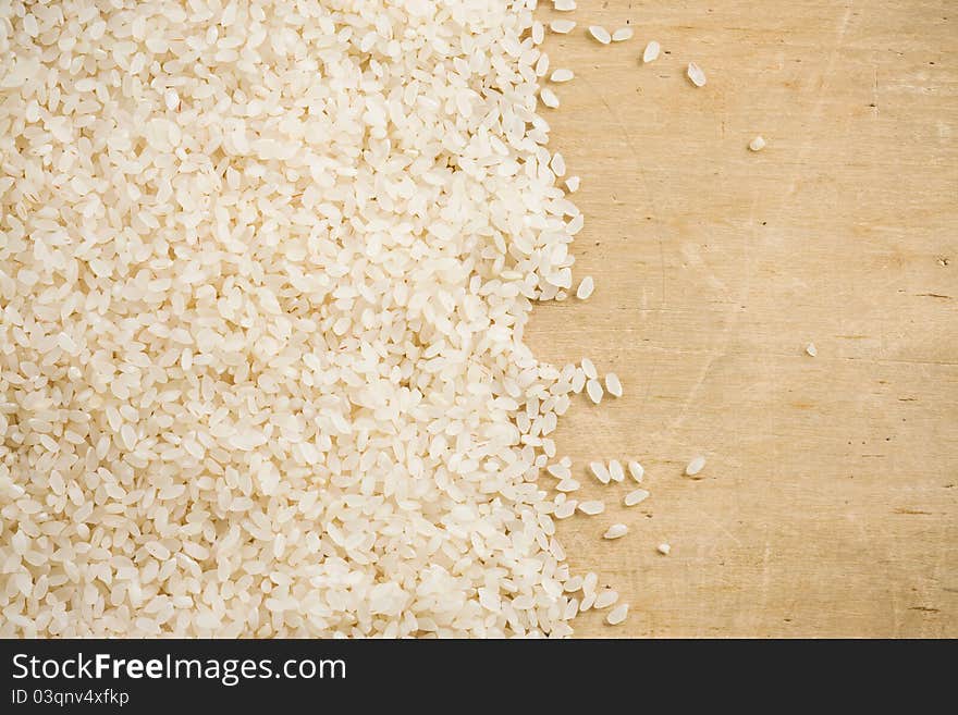 Rice grain and wood background