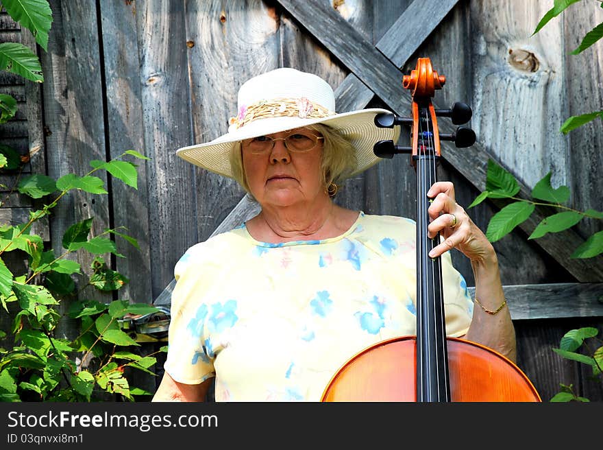 Female cellist performing with her cello outside. Female cellist performing with her cello outside.