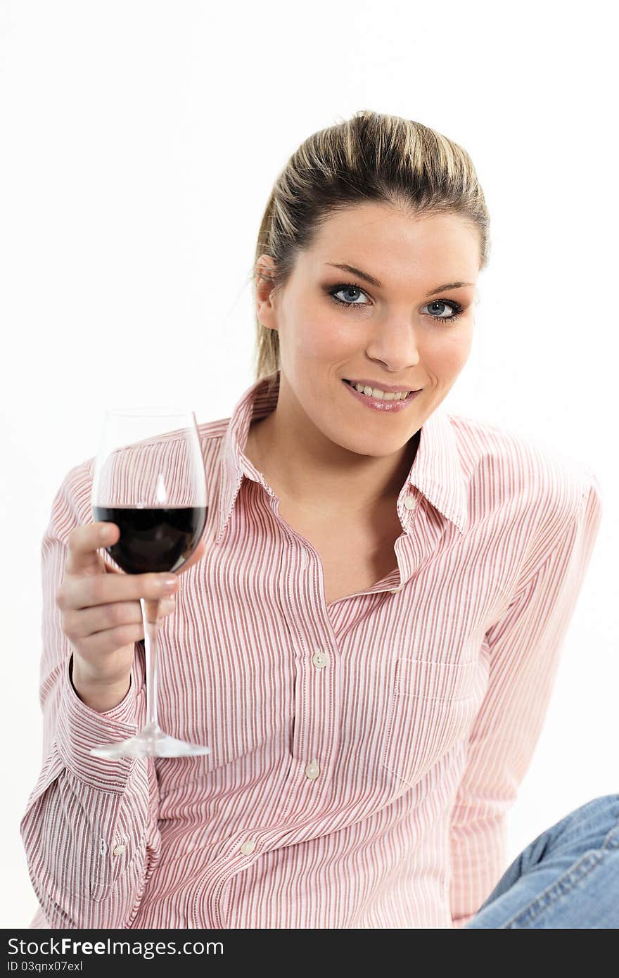 Attractive young woman holding a glass of red wine