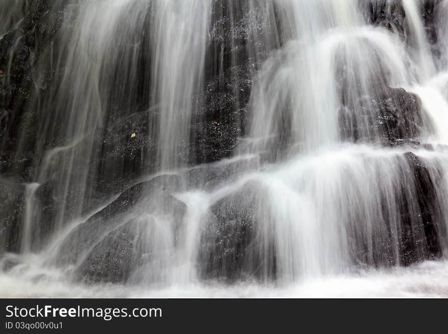 Close-up view of waterfall with use of slow shutter speed to create misty water effect. Close-up view of waterfall with use of slow shutter speed to create misty water effect