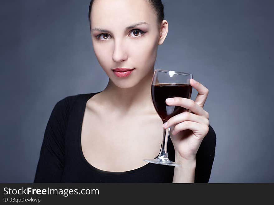 Portrait of beautiful woman with glass