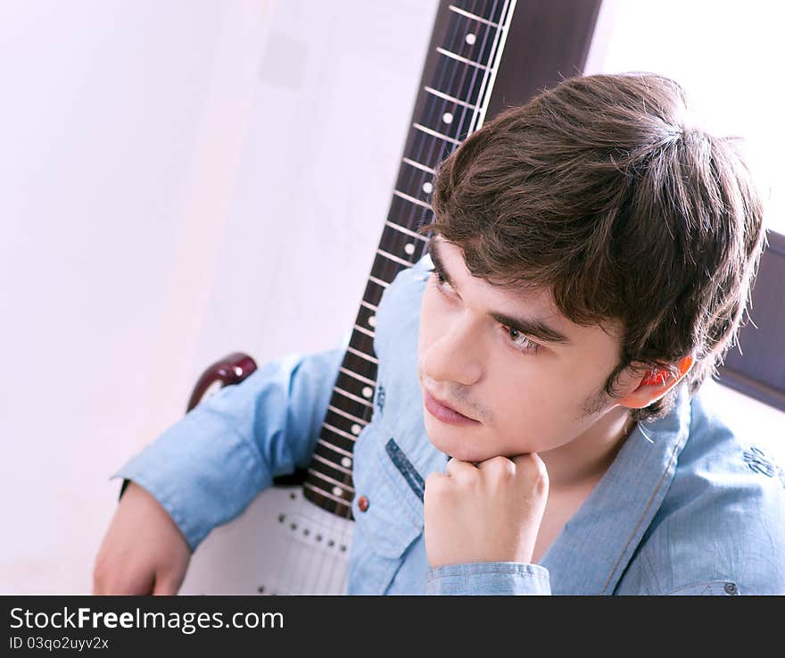 Young handsome guy with a guitar