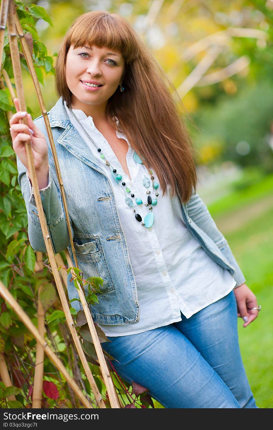 Portrait of young beautiful woman in a park