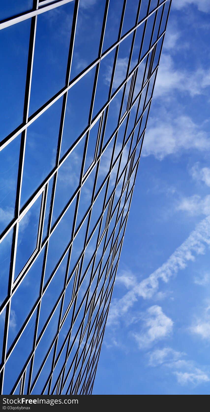 High-rise glass building with sky and clouds reflection. High-rise glass building with sky and clouds reflection