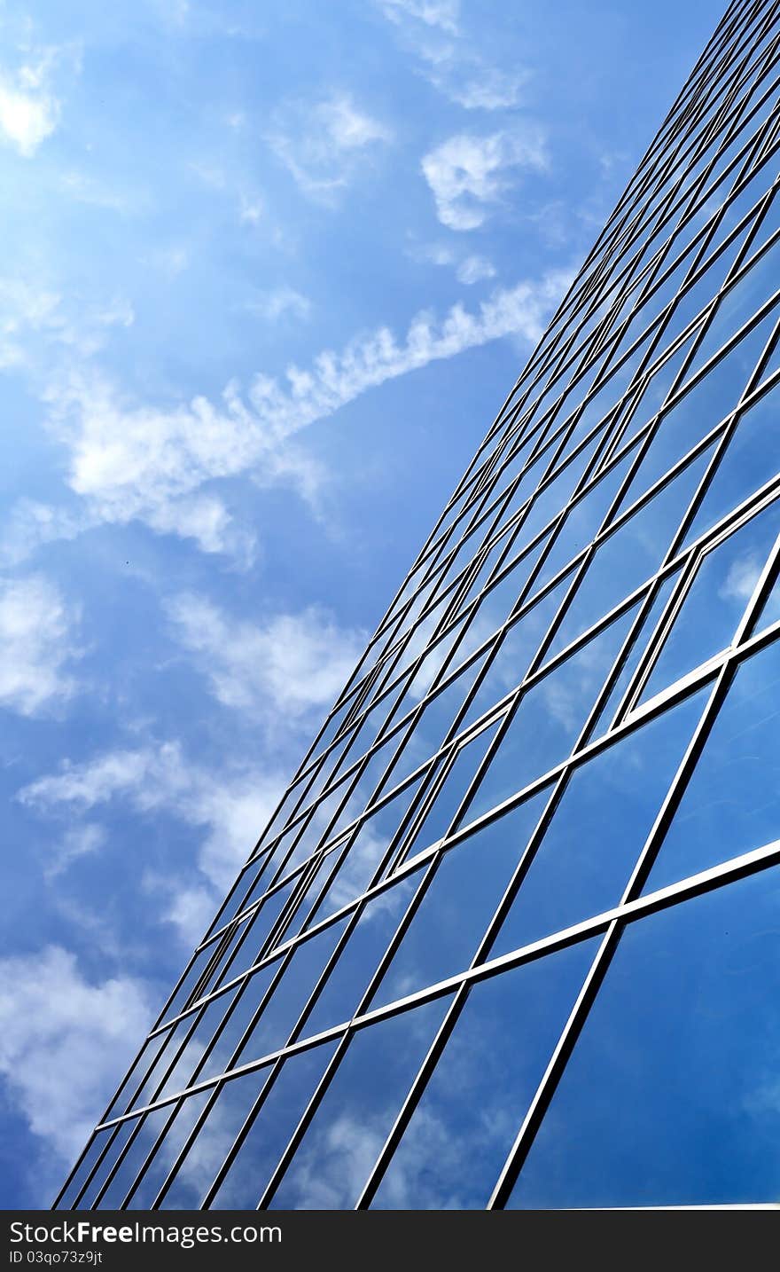 High-rise glass building with sky and clouds reflection. High-rise glass building with sky and clouds reflection