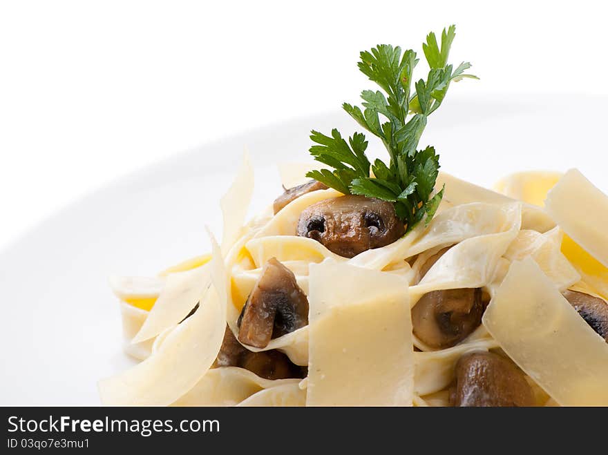 Closeup of plate of Tagliatelle with champignon, cheese creamy sauce and parmesan cheese. Closeup of plate of Tagliatelle with champignon, cheese creamy sauce and parmesan cheese